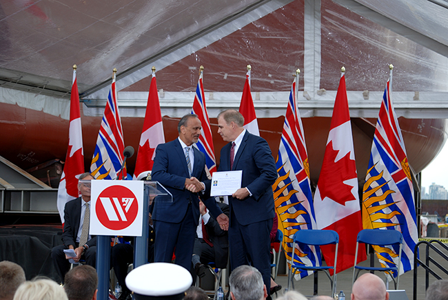 Mark Lamarre accepts a congratulatory letter from Minister Harry Bains on behalf of the BC Government.